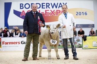 Charolais Steer Class winner Ashley Bothwell with "Cheeky Charlie being presented by BCCS Chief Executive David Benson